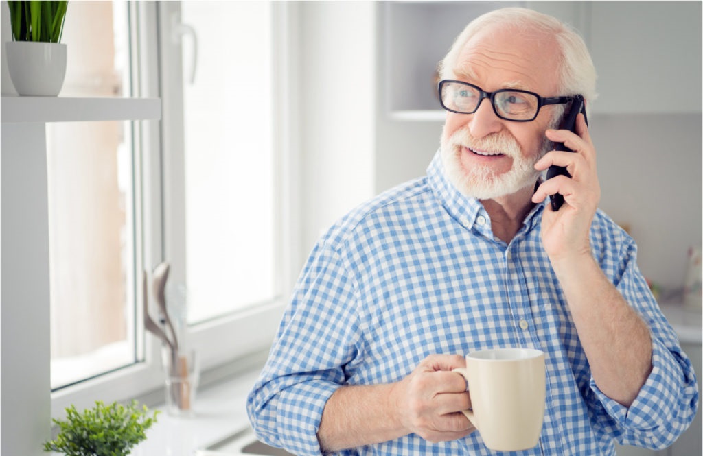 Man enjoying a conversation on his home phone